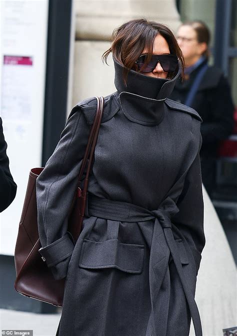 Harper Beckham, 13, is glued to her phone as she steps out in